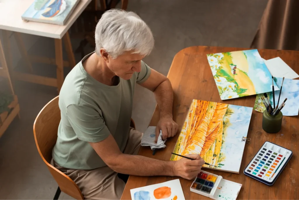 senior artist studio painting with watercolor